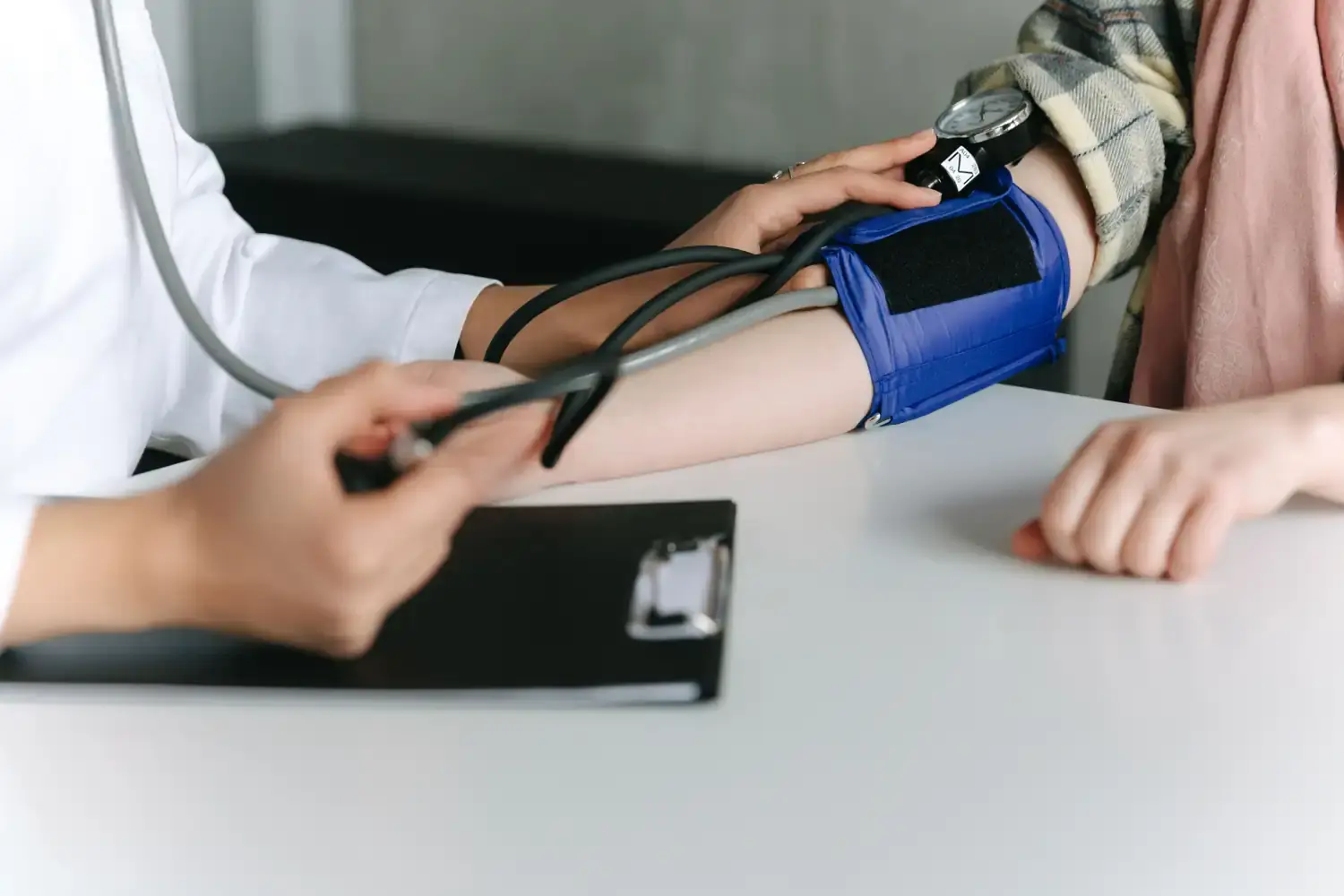 A Naluri clinician checks an employee's blood pressure during an onsite corporate health screening